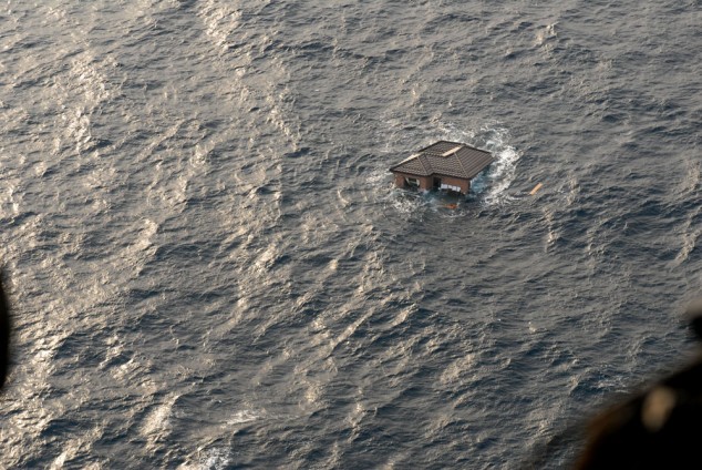 A house floats in the ocean after the Japanese earthquake and tsunami